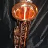 A saxophone with a copper finish on it.