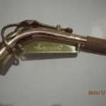 A brass pipe with a handle on it.
