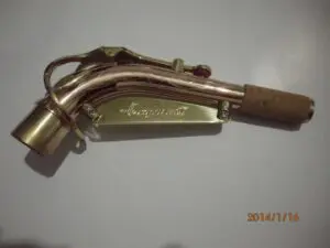 A brass pipe with a handle on it.