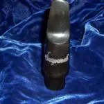 A black and silver tube sitting on top of blue cloth.