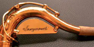 A close up of a saxophone with a name on it.