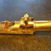 A close up of the top part of a gold pipe
