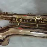 A close up of the side of an old saxophone