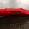 A red pen with a hole in it.