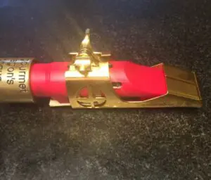 A red fire extinguisher with a gold holder.