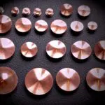 A group of copper discs sitting on top of a table.