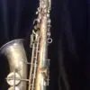A saxophone is shown with the strings pulled back.