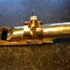 A close up of the top part of a brass pipe