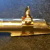 A close up of the top of a gold pipe