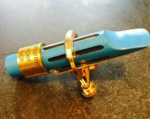A blue pen with gold trim on top of a table.