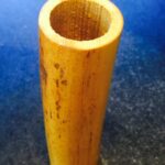 A wooden tube with a hole in it.